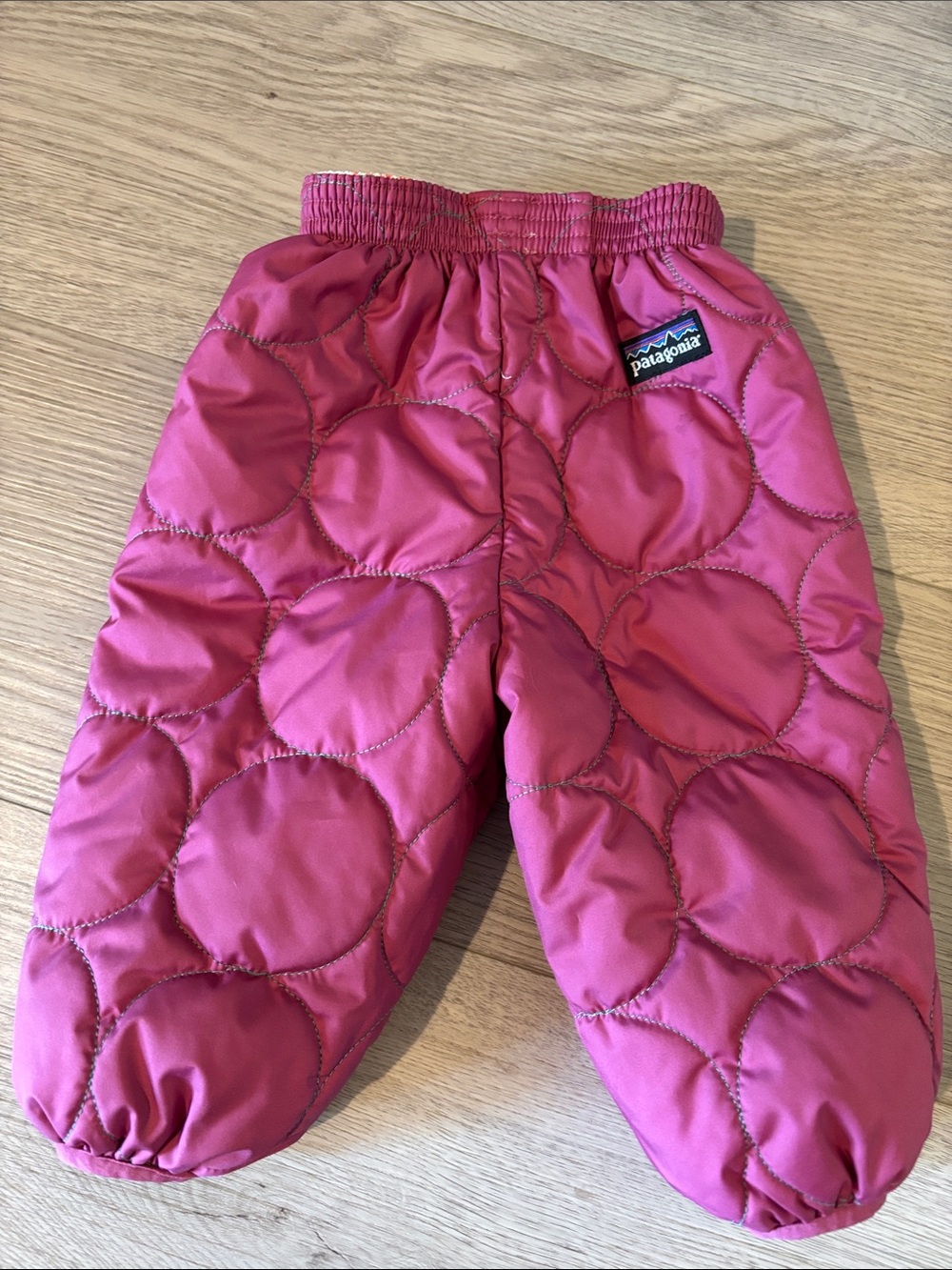 Patagonia Baby Pink Quilted Snow Pants featuring a reversible "Deer" print